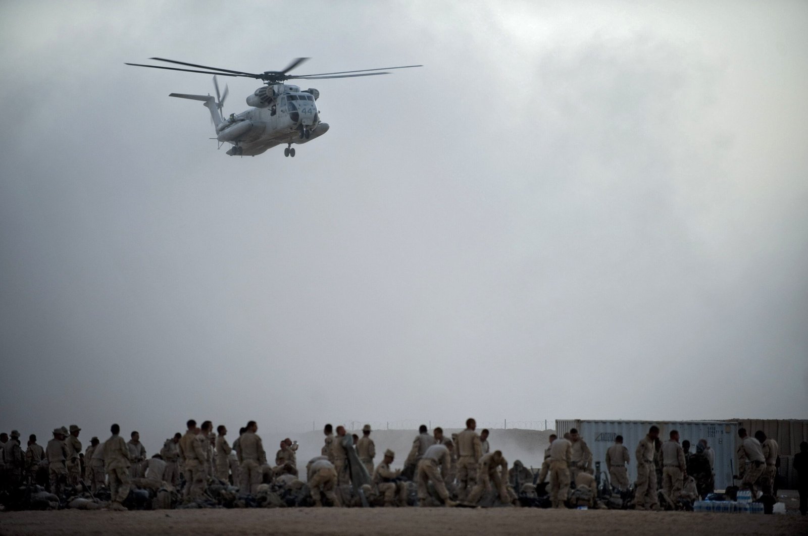 U.S. Marines from the 2nd Battalion, 8th Marine Regiment of the 2nd Marine Expeditionary Brigade, wait as a helicopter arrives to airlift them for Operation Khanjar at Camp Dwyer in Helmand Province, Afghanistan, July 2, 2009. (AFP Photo)
