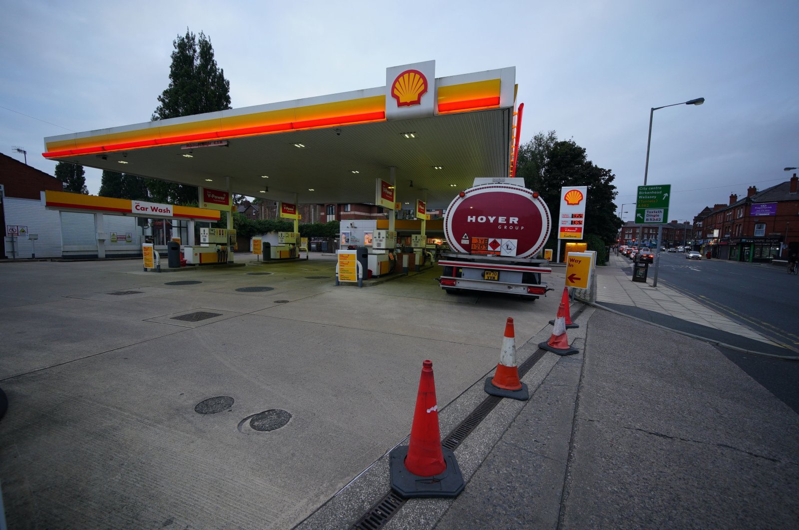 A petrol tanker delivers fuel to a gas station that was closed due to having no fuel, in Liverpool, England, Sept. 23, 2021. (Peter Byrne / PA via AP)
