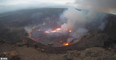 This webcam image provided by the United States Geological Survey shows a view of an eruption that has begun in the Halemaumau crater at the summit of Hawaii’s Kilauea volcano, Sept. 29, 2021. (USGS via AP)