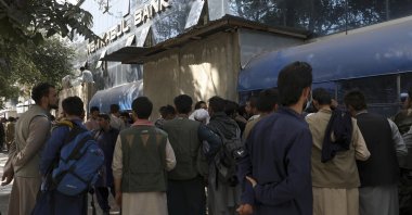 Afghans wait in long lines for hours to try to withdraw money in front of a bank in Kabul, Afghanistan, Sunday, Aug. 15, 2021. (AP Photo)