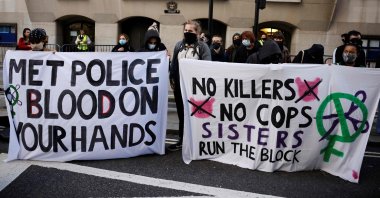 Demonstrators hold banners as they await the sentencing of British police officer Wayne Couzens for the murder of Sarah Everard, outside the Old Bailey court in London on Sept. 29, 2021. (AFP Photo)
