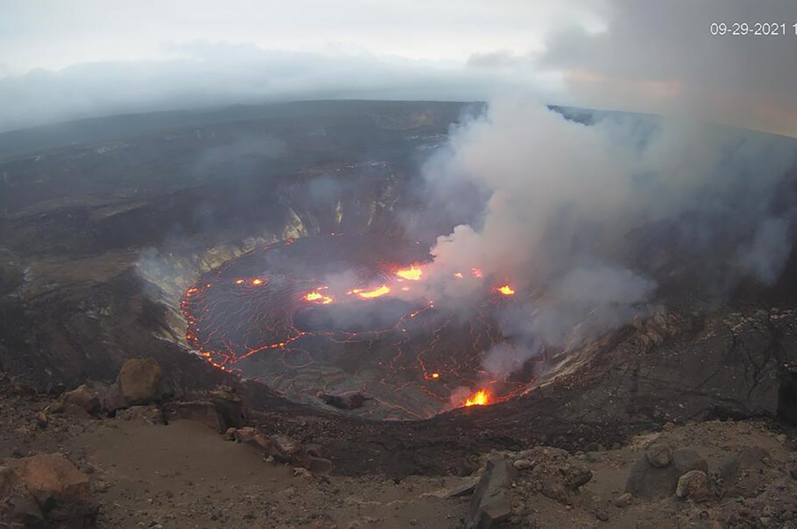 This webcam image provided by the United States Geological Survey shows a view of an eruption that has begun in the Halemaumau crater at the summit of Hawaii’s Kilauea volcano, Sept. 29, 2021. (USGS via AP)