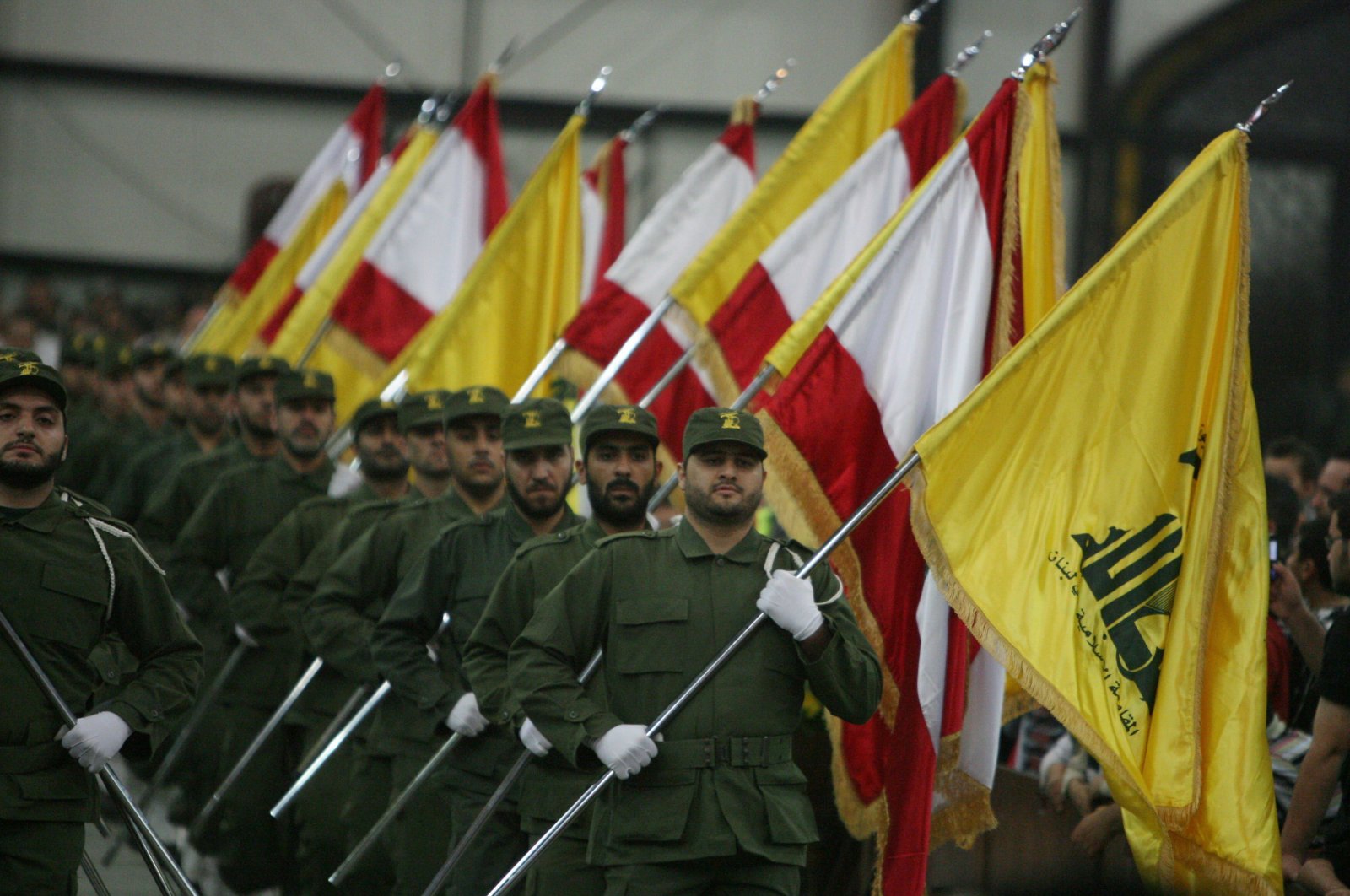 Hezbollah fighters, holding up Lebanese flags and the yellow flag of the group, as they parade on the occasion of Martyr's Day in the southern suburbs of Beirut, Lebanon, Nov. 11, 2009. (AFP Photo)