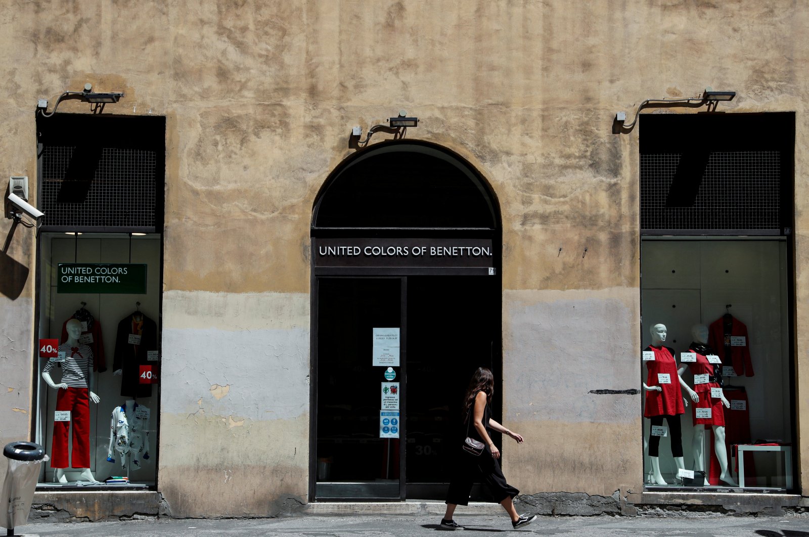 A woman walks past of United Colors of Benetton store in Rome, Italy, July 21, 2020. (Reuters Photo)