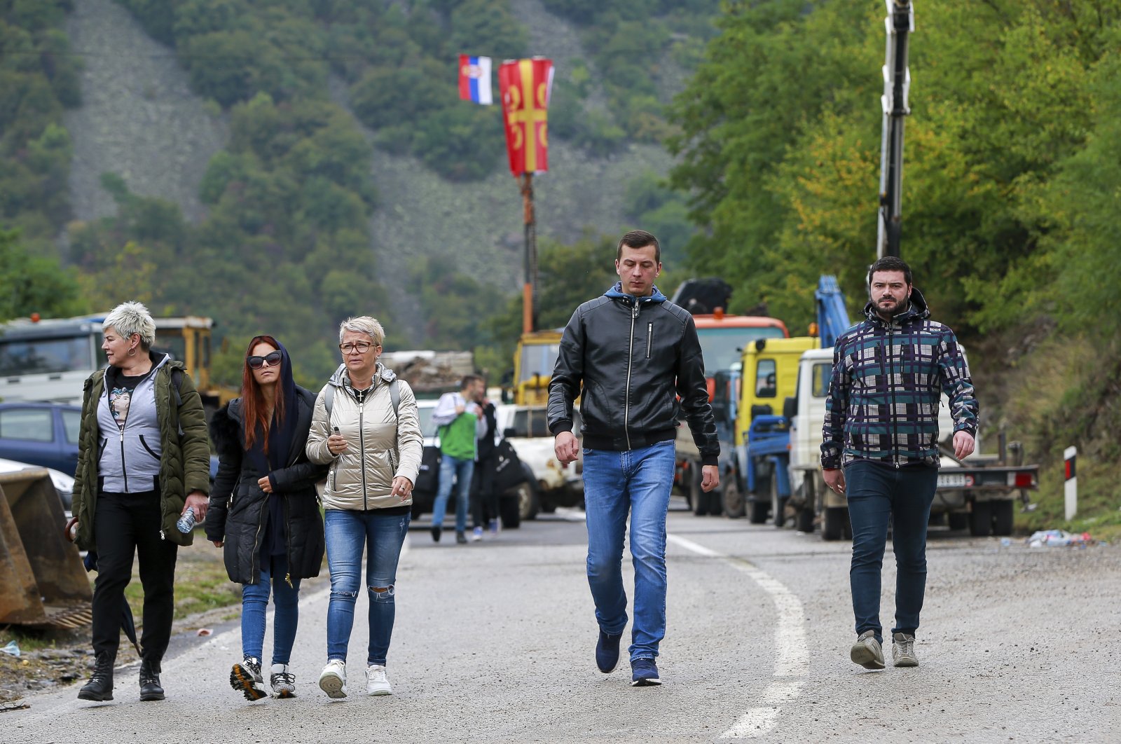 Ethnic Serbs walk through barricades near the northern Kosovo border crossing of Jarinje on the ninth day of protest, Sept. 28, 2021. (AP Photo)
