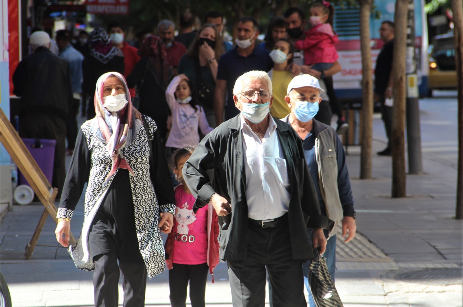 People wearing protective masks against COVID-19 walk on a street in Elazığ, eastern Turkey, Sept. 26, 2021. (İHA PHOTO) 