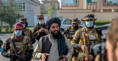 A Taliban commander (C) speaks to members of the media after halting a demonstration by female protestors in front of a school in Kabul, Afghanistan, Sept. 30, 2021. (AFP Photo)