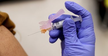 Susana Sanchez, a Nurse Practitioner, administers a flu vaccination to Loisy Barrera at a CVS pharmacy and MinuteClinic, Miami, Florida, U.S., Sept. 10, 2021. (Getty Images/AFP Photo)