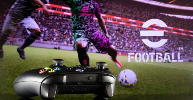 An Xbox controller stands on a table with Konami's "eFootball" game visible in the background, Sao Paulo, Brazil, July 26, 2021. (Shutterstock Photo)
