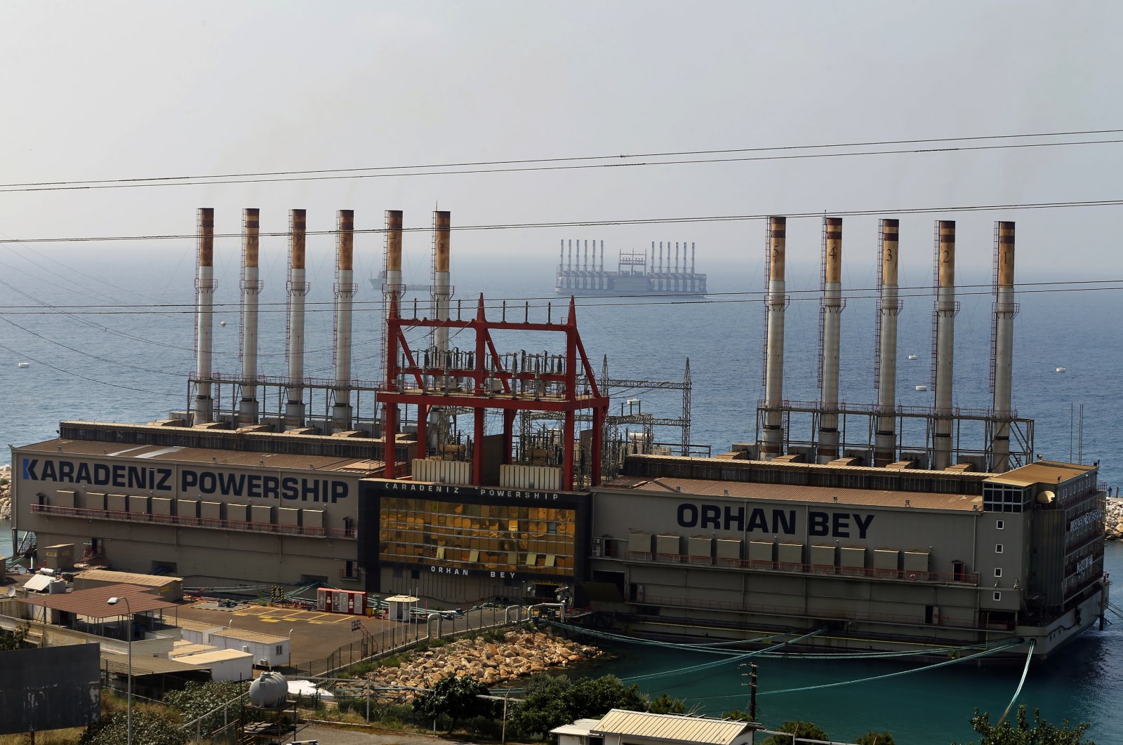 Karadeniz Powership Orhan Bey, foreground, and a second floating power station seen off the coast at Jiyeh, south of Beirut, Lebanon, July 16, 2018. (AP Photo)