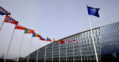 Flags of NATO alliance members flap in the wind outside NATO headquarters in Brussels, Belgium, Feb. 28, 2020. (AP Photo)
