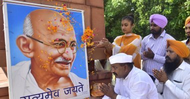 Social worker Shyam Lal Gandhi (L) and others pay floral tribute to Mahatma Gandhi on the occasion of the anniversary of his birth, Amritsar, India, Oct. 2, 2021.  (Photo by Sameer Sehgal/Hindustan Times via Getty Images)