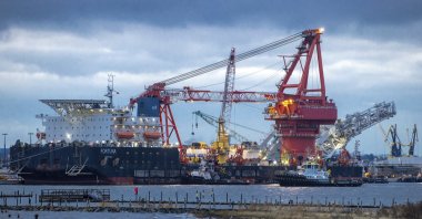 In this Jan. 14, 2021 file photo, tugboats get into position on the Russian pipe-laying vessel "Fortuna" in the port of Wismar, Germany. (AP Photo)