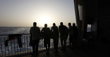 Arab migrants, including three Libyans, two Tunisians and a Moroccan, gaze at the Mediterranean Sea, on the deck of the Geo Barents, a rescue vessel operated by MSF (Doctors Without Borders) off Libya, in the Central Mediterranean route, Sept. 22, 2021. (AP Photo)