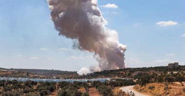 A smoke plume rising from aerial bombardment near a make-shift camp for displaced Syrians near the town of Kafraya in the north of Idlib province, northwestern Syria, Sept. 7, 2021. (AFP Photo)