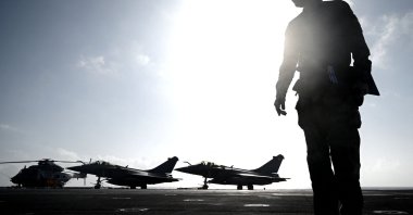 A military officer looks on in front of Rafale jet fighters on the deck of the French aircraft carrier “Charles de Gaulle” at sea, off the coast of Hyeres, Jan. 23, 2020 (AFP File Photo)