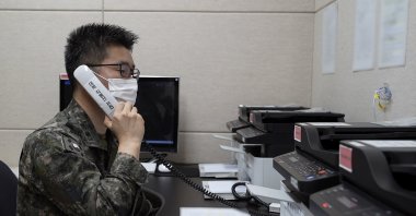 In this photo provided by the South Korean Defense Ministry, an unidentified South Korean military officer makes a test call with a North Korean officer through an inter-Korean military communication line at an undisclosed location near the demilitarized zone, South Korea, Monday, Oct. 4, 2021. (AP Photo)