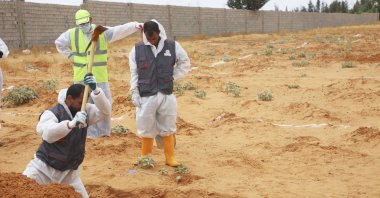 Libyan Ministry of Justice employees dig a site of a suspected mass grave in the town of Tarhuna, Libya, June 23, 2020. (AP Photo)