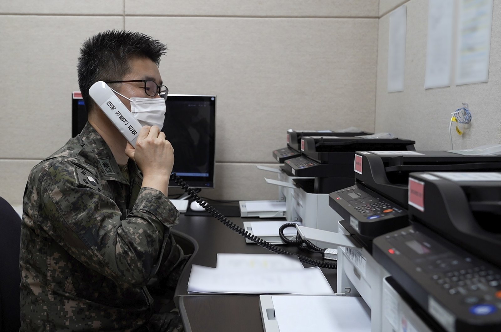 In this photo provided by the South Korean Defense Ministry, an unidentified South Korean military officer makes a test call with a North Korean officer through an inter-Korean military communication line at an undisclosed location near the demilitarized zone, South Korea, Monday, Oct. 4, 2021. (AP Photo)