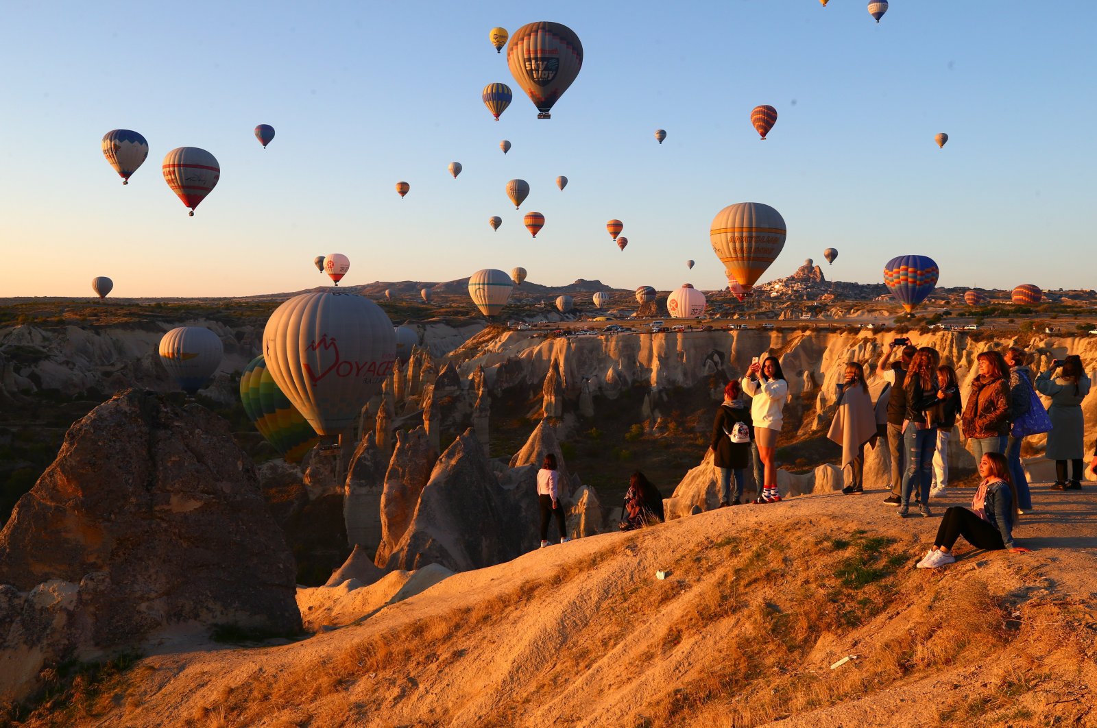 Tourists watch and take photographs as air balloons take to the sky, in Nevşehir, Turkey, Oct. 3, 2021. (AA Photo)