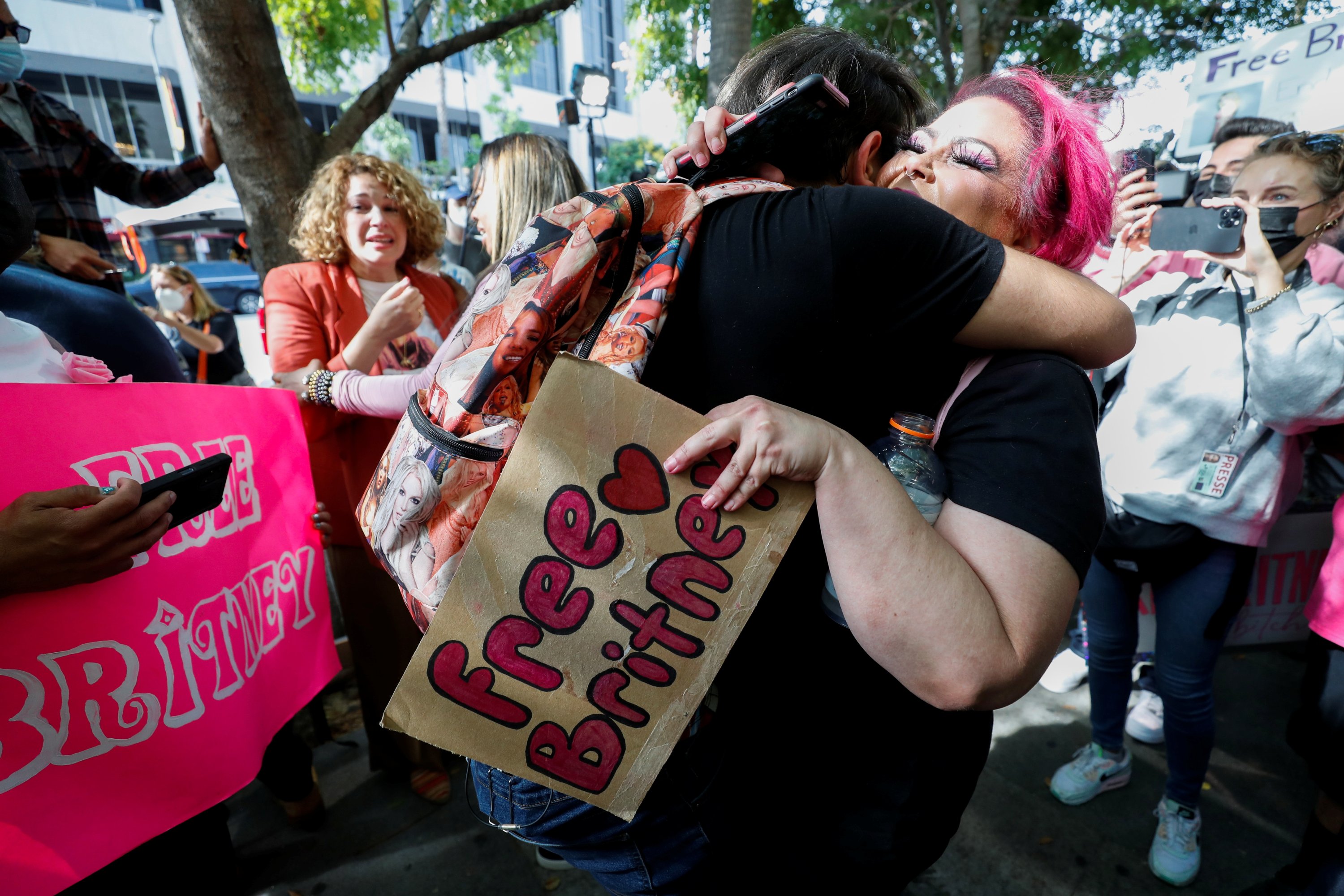 Supporters of pop star Britney Spears hug as they celebrate after a judge suspended the father of Britney Spears from his 13-years-long role as the controller of the singer's business affairs at Stanley Mosk Courthouse in Los Angeles, California, U.S., Sept. 29, 2021. (Reuters Photo)