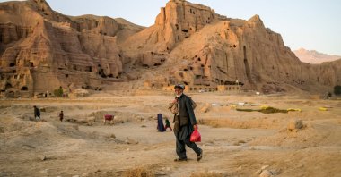 A Hazara man walks home near the cliffs pockmarked by caves where people still live as they did centuries ago in Bamiyan, Afghanistan, Oct. 3, 2021. (AFP Photo)