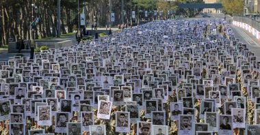 Soldiers carry portraits of Azerbaijani service members killed in the recent conflict over the region of Nagorno-Karabakh during a commemoration on its first anniversary, in Baku, Azerbaijan, Sept. 27, 2021. (Reuters Photo)