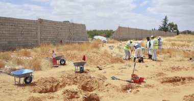 The Libyan Ministry of Justice employees dig at a site of a suspected mass grave in the town of Tarhuna, Libya, June 23, 2020. (AP File Photo)