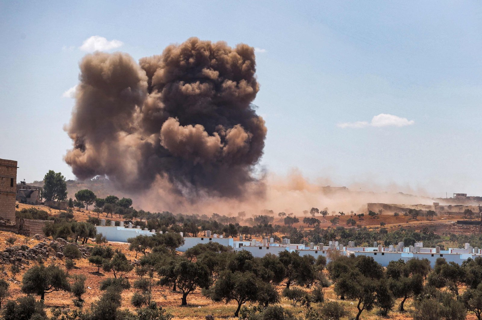 A smoke plume rising from aerial bombardment near a make-shift camp for displaced Syrians near the town of Kafraya in the north of Idlib province, northwestern Syria, Sept. 7, 2021. (AFP Photo)