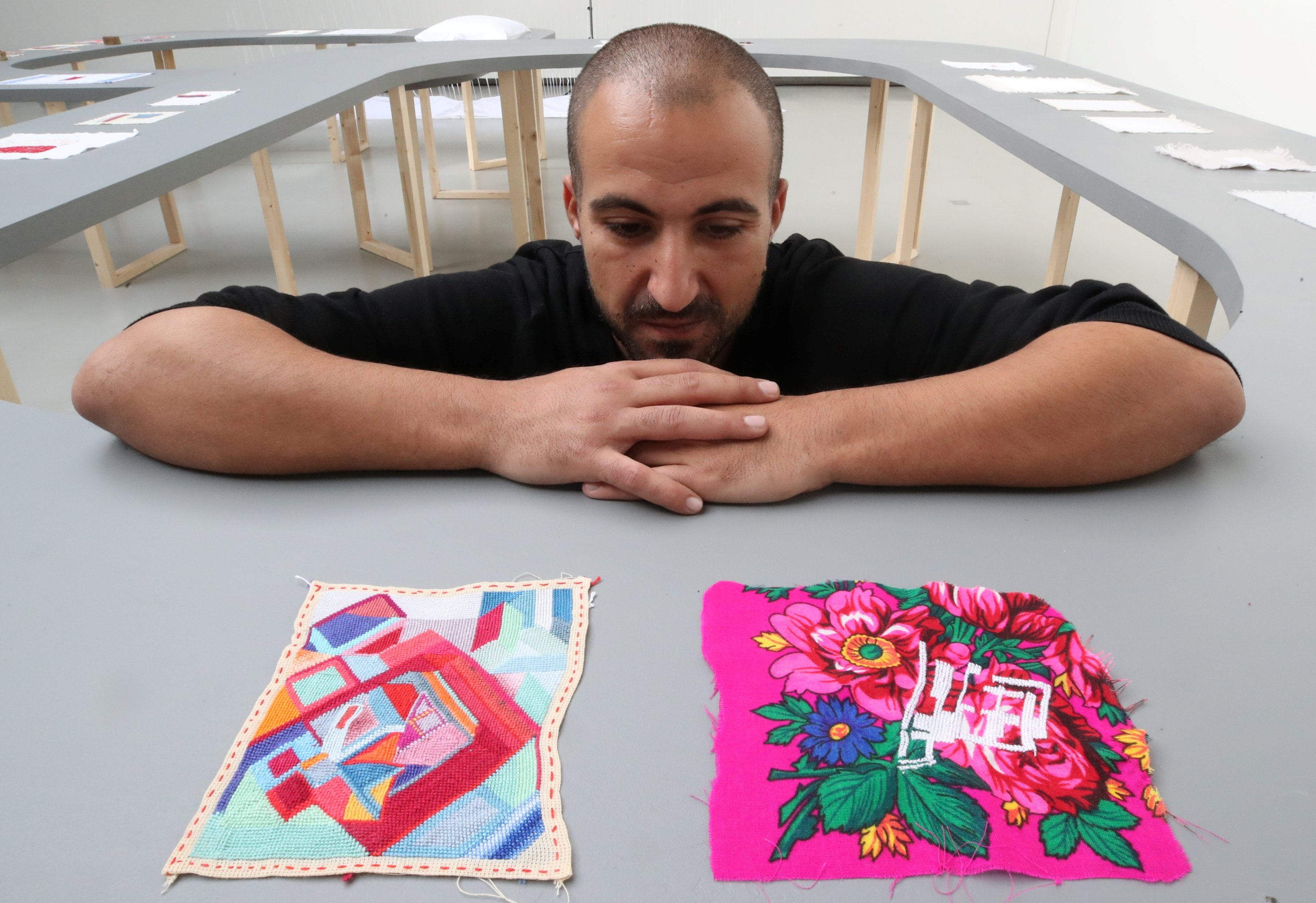 Palestinian artist Majd Abdel Hamid poses for Reuters during his exhibition "A Stitch in Times" in Brussels, Belgium Oct. 5, 2021.  (Reuters Photo)