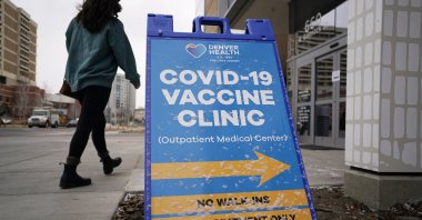 A woman heads in for a COVID-19 vaccination during a mass vaccination of 1,000 employees of Denver Public Schools including teachers, administrators, custodial workers and bus drivers at Denver Health, in Denver, Colorado, U.S., Feb. 13, 2021. (AP File Photo)