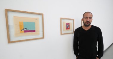 Palestinian artist Majd Abdel Hamid poses for Reuters during his exhibition "A Stitch in Times" in Brussels, Belgium Oct. 5, 2021. (Reuters Photo)