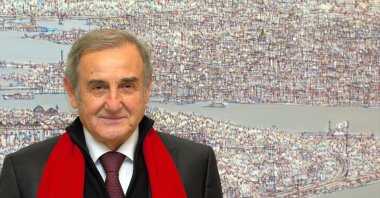 Devrim Erbil poses in front of one of his works. 