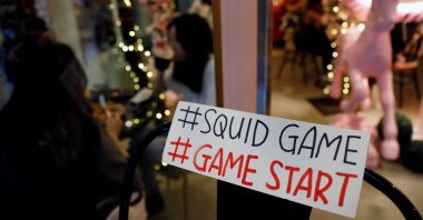 A sign referring to the "honeycomb challenge" featured in Netflix's new hit series "Squid Game" is seen at Brown Butter Cafe in Singapore, Oct. 1, 2021. (Reuters Photo)