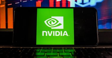 In this photo illustration, an NVidia logo is seen displayed on a smartphone with the stock market percentages in the background. (Photo by Omar Marques/SOPA Images/Sipa USA via Reuters, File Photo)