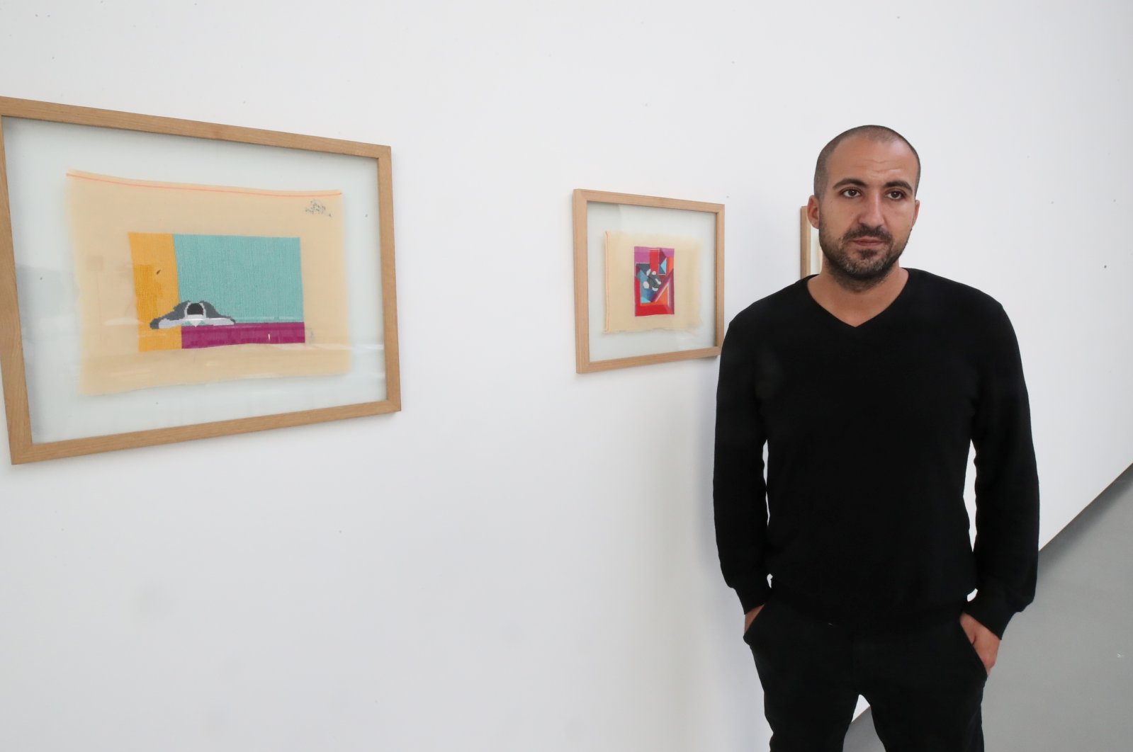 Palestinian artist Majd Abdel Hamid poses for Reuters during his exhibition "A Stitch in Times" in Brussels, Belgium Oct. 5, 2021. (Reuters Photo)