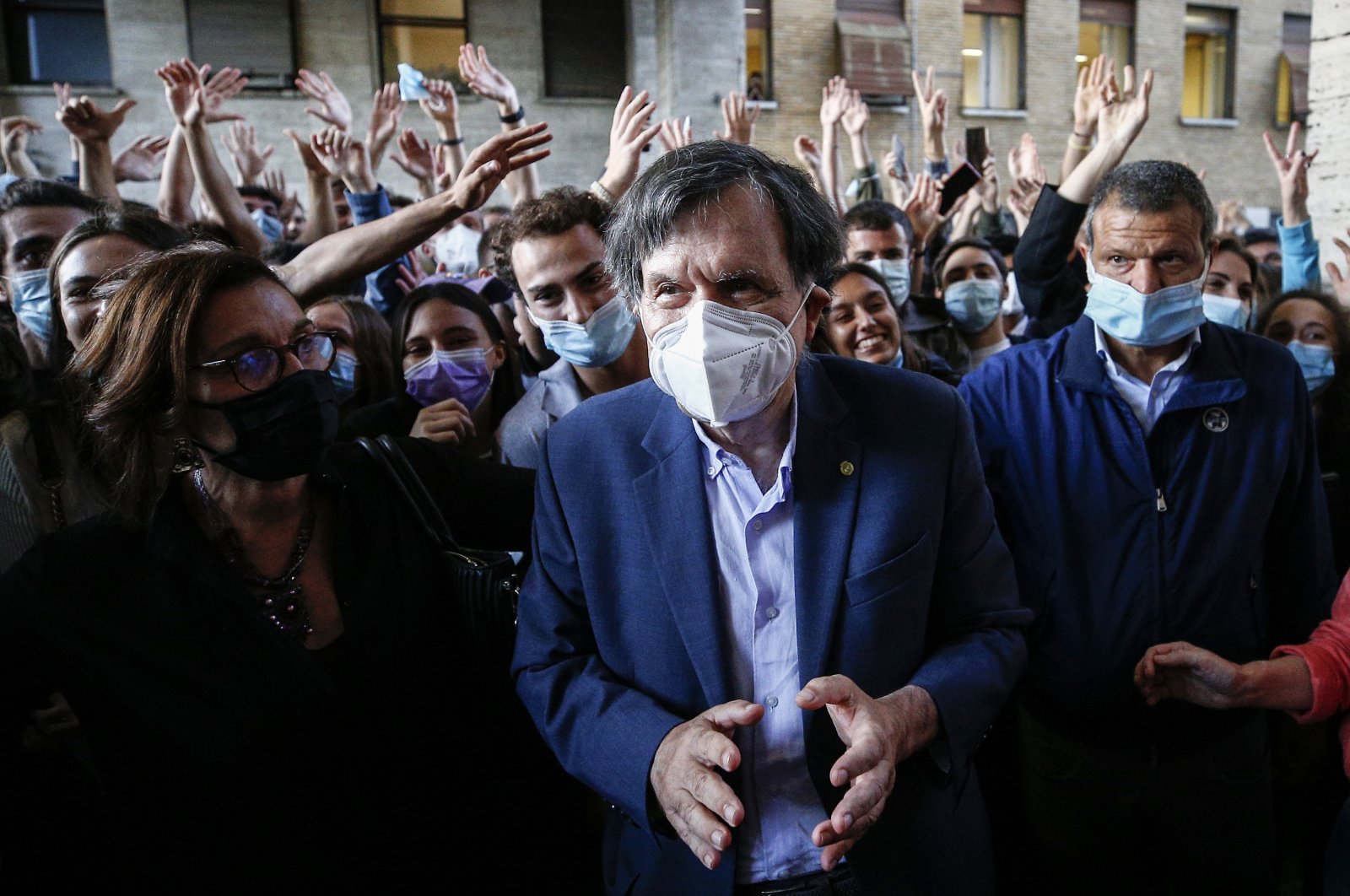 Italian physicist Giorgio Parisi is cheered by students as he arrives at the Sapienza University, in Rome, Italy, Oct. 5, 2021. (AP Photo)