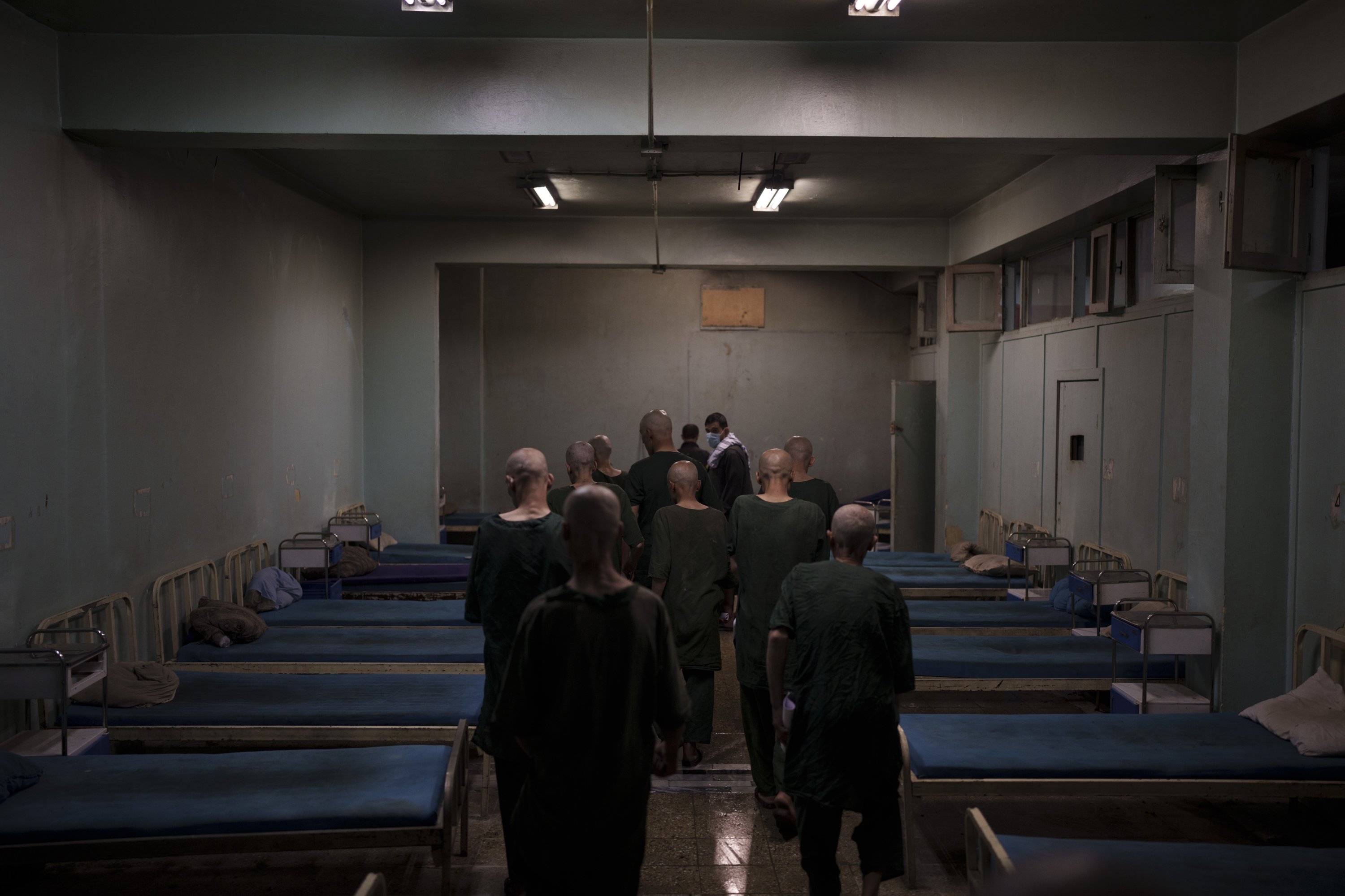 Drug users detained during a Taliban raid are taken to their room at the detoxification ward of the Avicenna Medical Hospital for Drug Treatment in Kabul, Afghanistan, Oct. 2, 2021. (AP Photo)