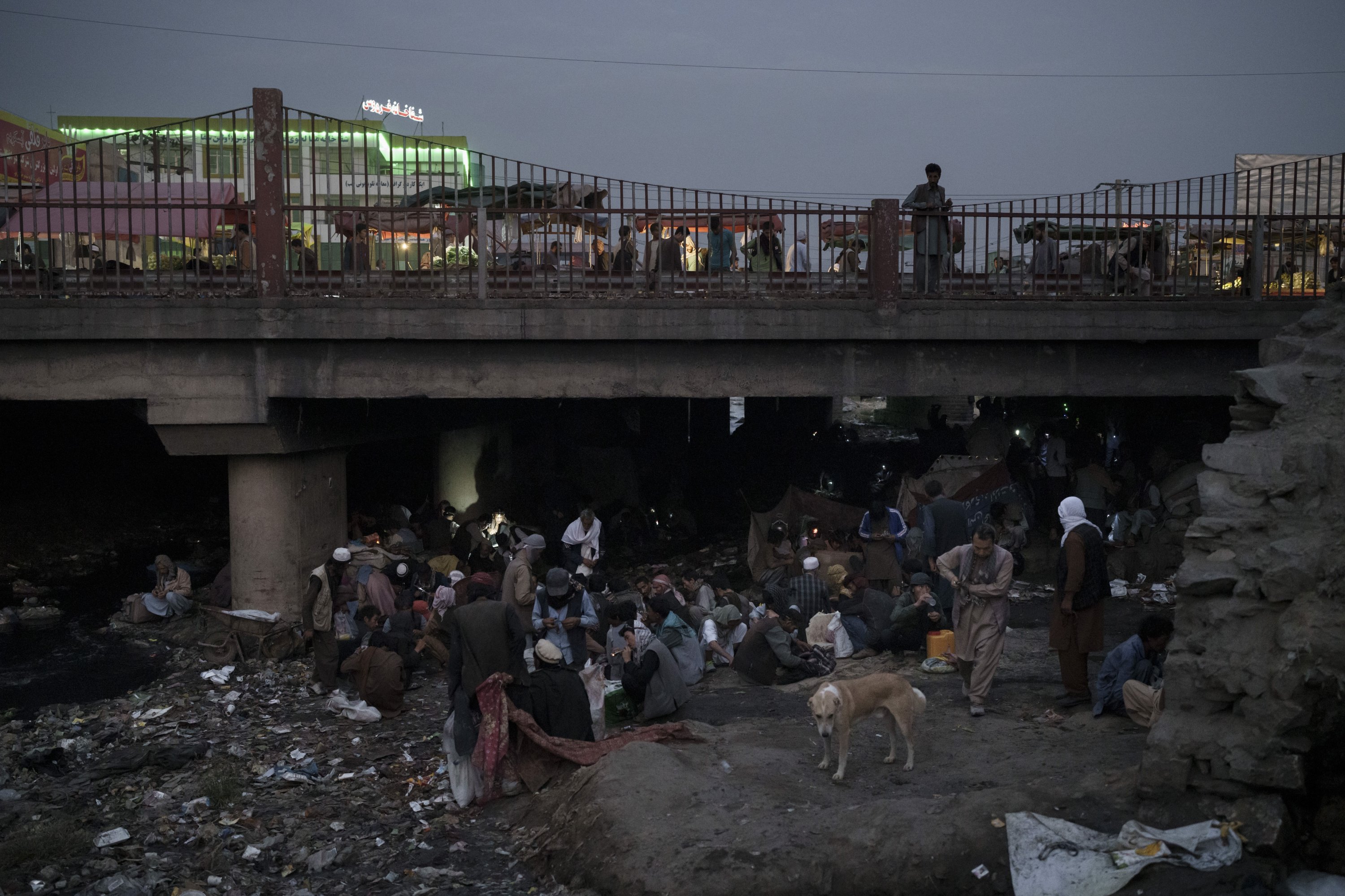 Afghans gather under a bridge to consume drugs, mostly heroin and methamphetamines, in Kabul, Afghanistan, Sept. 30, 2021. (AP Photo)