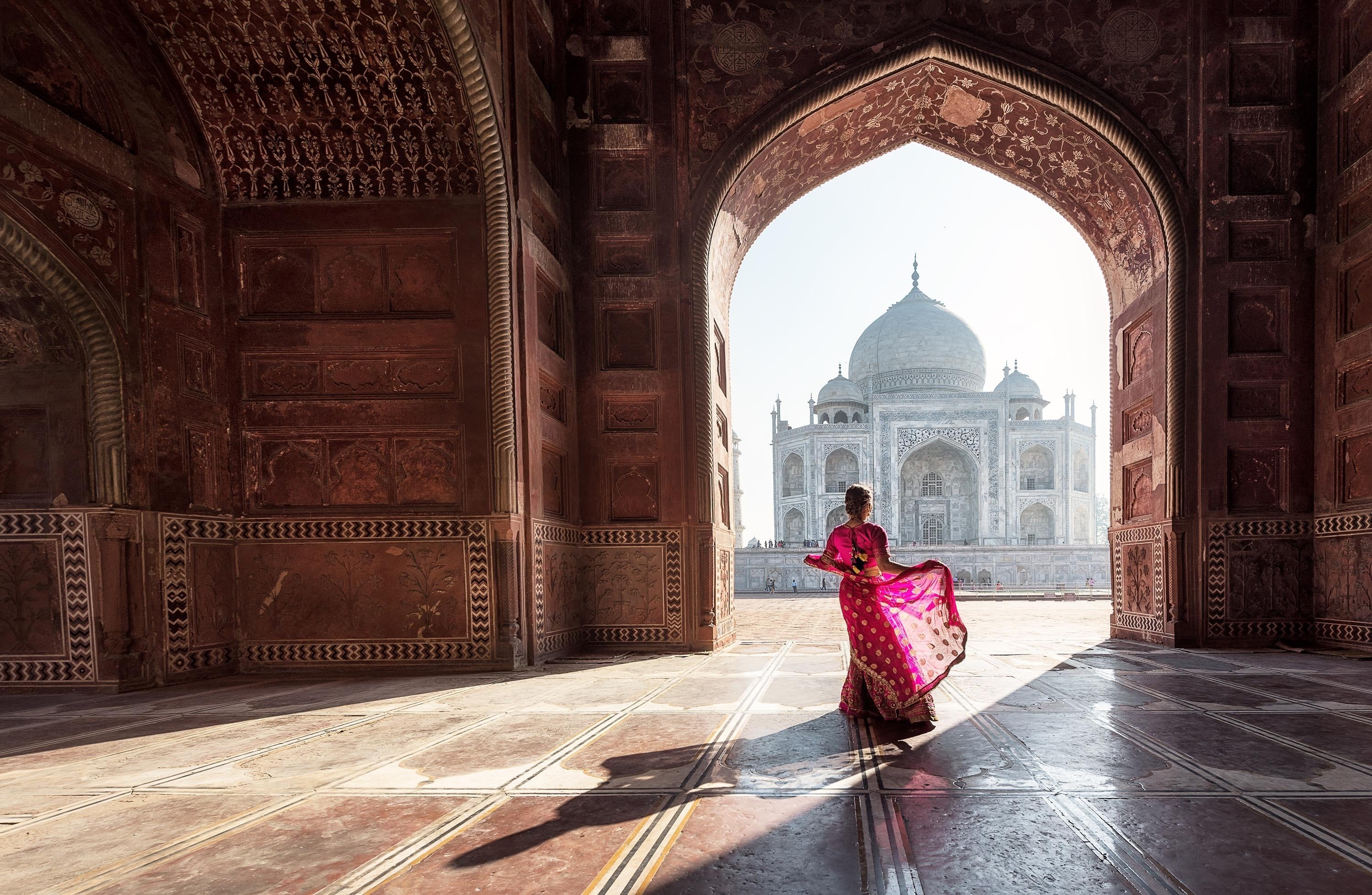 Woman in red saree/sari in the Taj Mahal, Agra, Uttar Pradesh, India. (Shutterstock Photo)