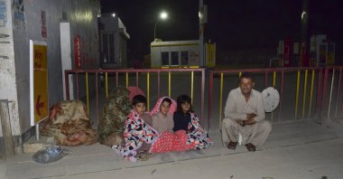 A family gather outside their house following a severe earthquake that hit the area, in Quetta, Pakistan, Thursday, Pakistan. (AP Photo)