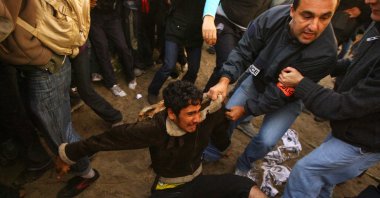 French police officers remove migrants and protesters from the makeshift migrant camp known as "The Jungle" adjacent to a ferry terminal to the U.K., in Calais, France, Sept. 22, 2009. (Getty Images)