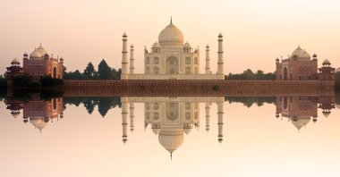 Panoramic view of Taj Mahal at sunset with reflection, Agra, India. (Shutterstock Photo)