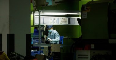 A man works at a manufacturing plant of Universal Electronics Inc in Qinzhou in Guangxi Autonomous Region, China, April 12, 2021.  (Reuters Photo)