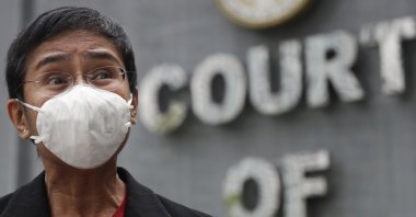 Journalist Maria Ressa, wearing a face mask, talks to reporters outside the Court of Tax Appeals in Manila, Philippines, March 4, 2021. (AP Photo)