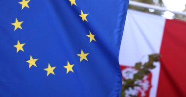 A picture taken on Oct. 8, 2021, shows the Polish flag and European Union flag at the entrance of Poland's permanent representation to the EU in Brussels, Belgium. (AFP Photo)