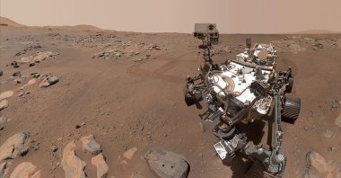 The Perseverance Mars rover, using its WATSON camera, takes this selfie over a rock nicknamed "Rochette" where two holes can be seen where the rover used its robotic arm to drill rock core samples, Sept. 10, 2021. (NASA via AFP)