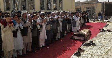 Relatives and residents pray during a funeral ceremony for victims of a suicide attack at the Gozar-e-Sayed Abad Mosque in Kunduz, northern Afghanistan, Oct. 9, 2021. (AP Photo)