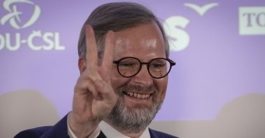 Leader of center-right Spolu (Together) coalition Petr Fiala flashes the V sign as he reacts to election results at the party's election headquarters, Prague, Czech Republic, Saturday, Oct. 9, 2021. (AP Photo)