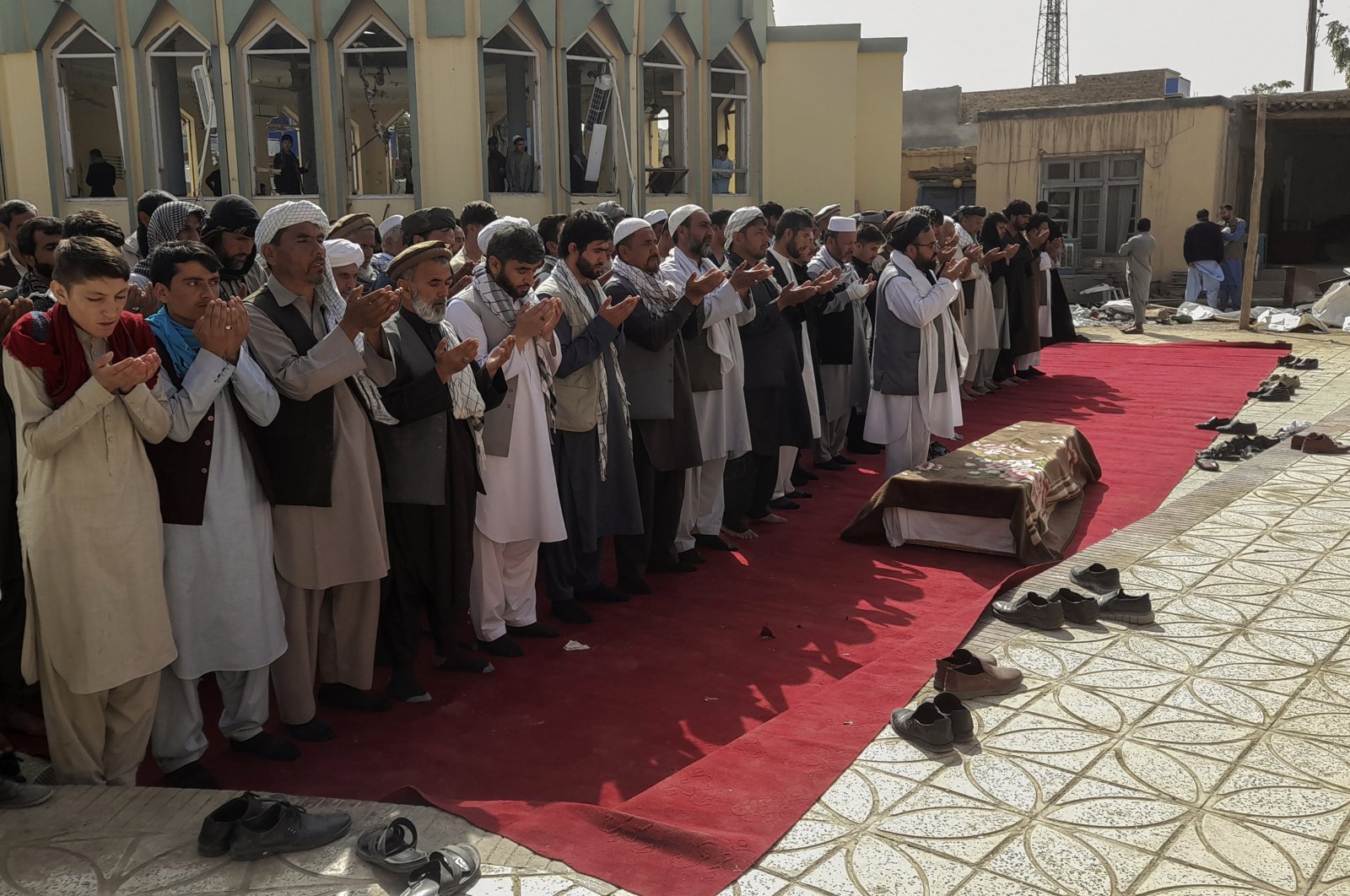 Relatives and residents pray during a funeral ceremony for victims of a suicide attack at the Gozar-e-Sayed Abad Mosque in Kunduz, northern Afghanistan, Oct. 9, 2021. (AP Photo)